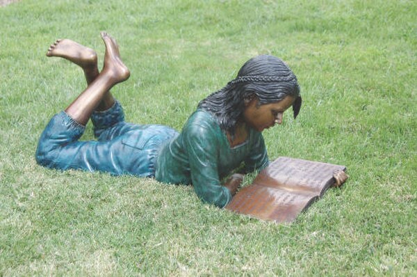 Dorothy Reading Book Bronze Sculpture Braid Hair Laying on Ground